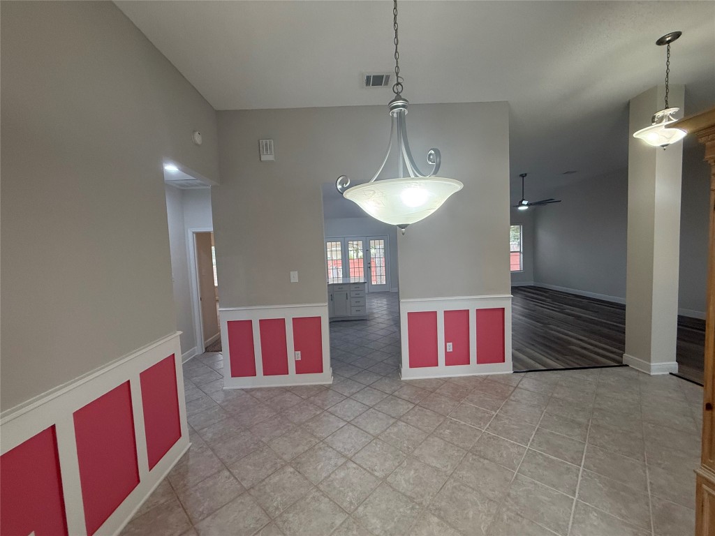 11711 Rydalwater Lane Austin, TX 78754 - Photo 4 of 20 Unfurnished dining area with a ceiling fan and a wainscoted wall