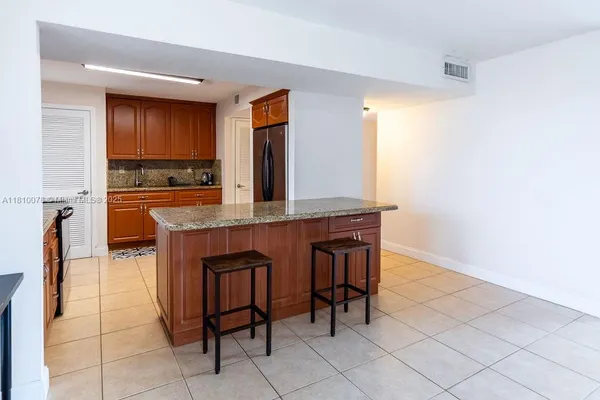 a kitchen with stainless steel appliances granite countertop a stove a microwave and a sink