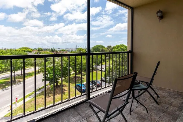 a view of a porch with chairs and backyard