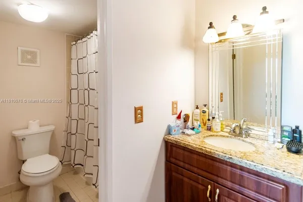 a white toilet sitting next to a shower