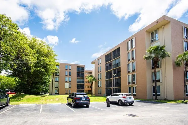 a view of empty room with wooden floor and floor to ceiling window