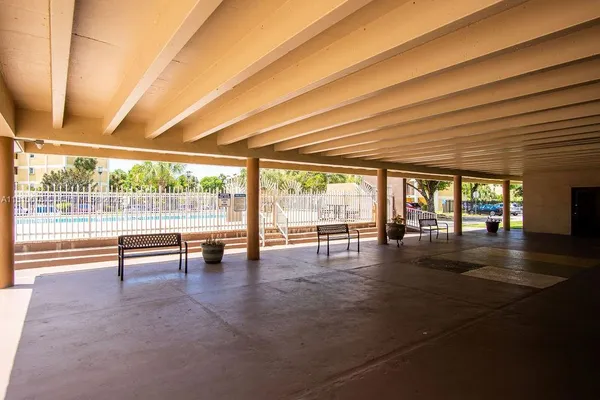 a view of a swimming pool with a patio and a yard
