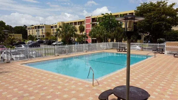 an aerial view of a house yard swimming pool and outdoor seating