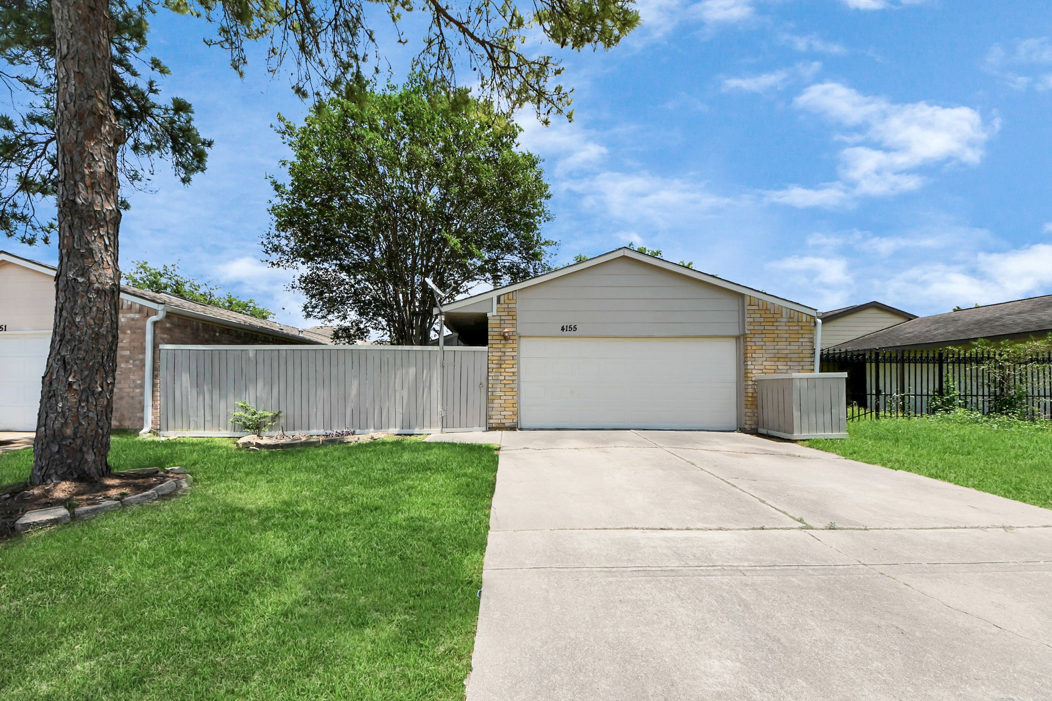 4155 Amir Street Houston, TX 77072 - Photo 4 of 43 a front view of a house with a yard and garage