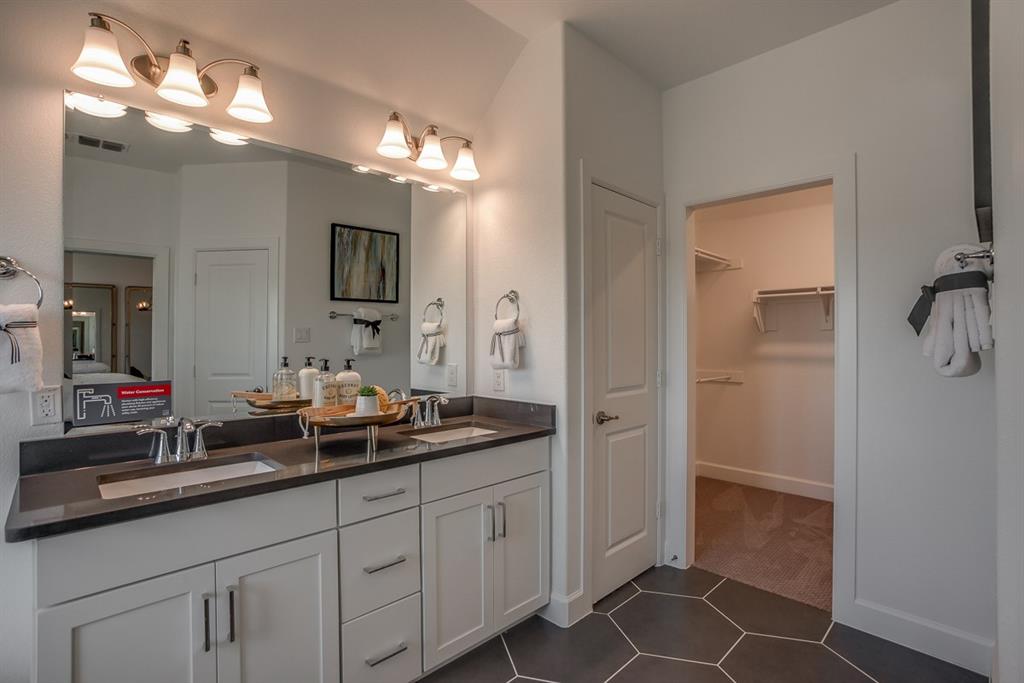 1437 Sun Gdn Way Justin, TX 76247 - Photo 19 of 28 a bathroom with a double vanity sink and a mirror