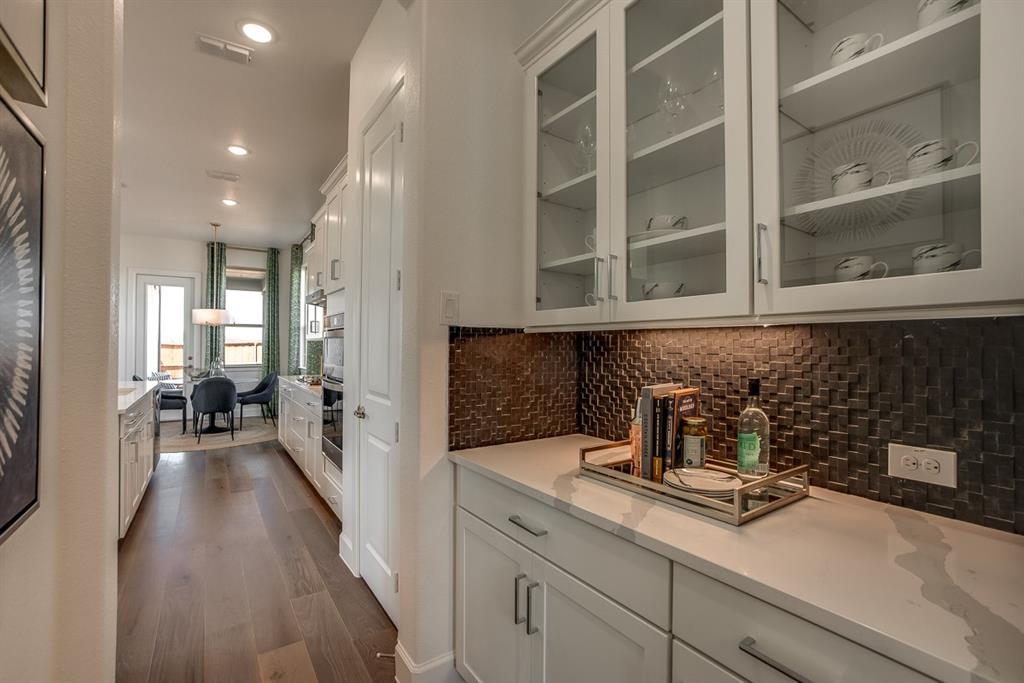 1437 Sun Gdn Way Justin, TX 76247 - Photo 7 of 28 a hallway with a sink and cabinets