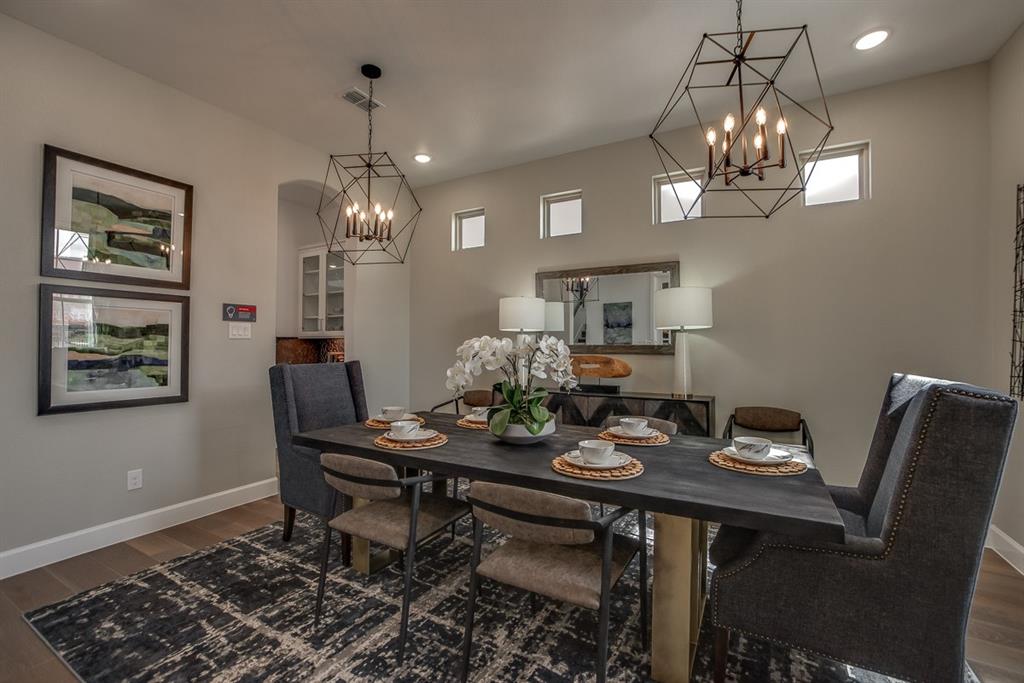 1437 Sun Gdn Way Justin, TX 76247 - Photo 9 of 28 a view of a dining room with furniture a chandelier and wooden floor