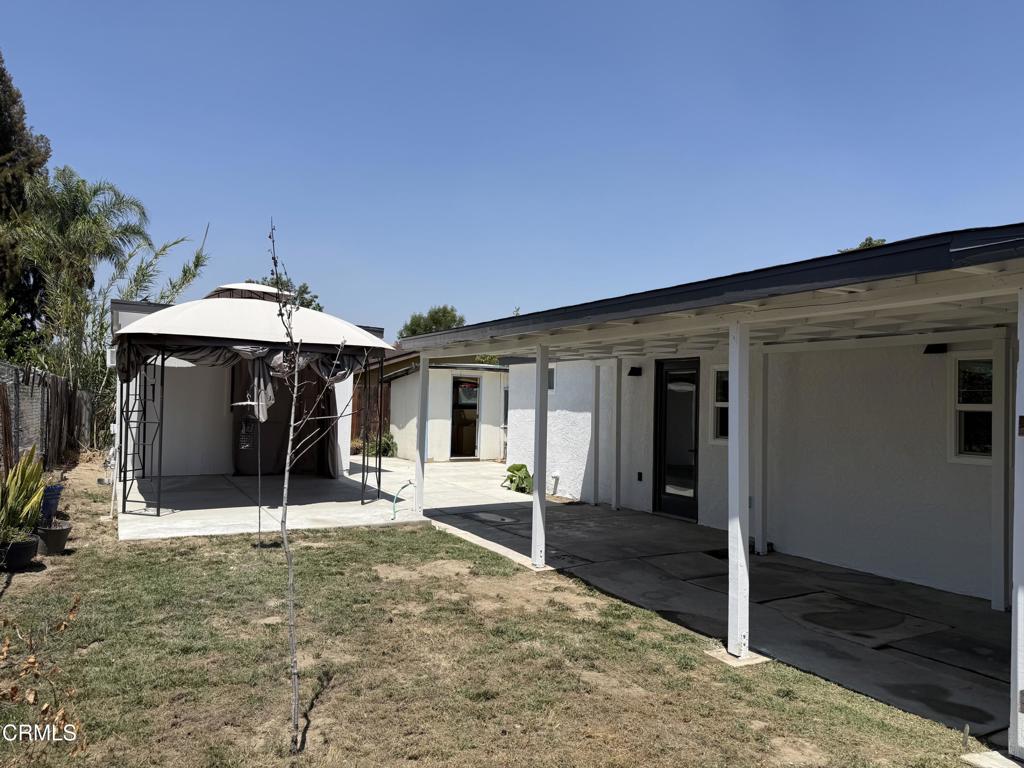 4010 Witt Avenue Riverside, CA 92501 - Photo 17 of 23 a backyard of a house with table and chairs under an umbrella