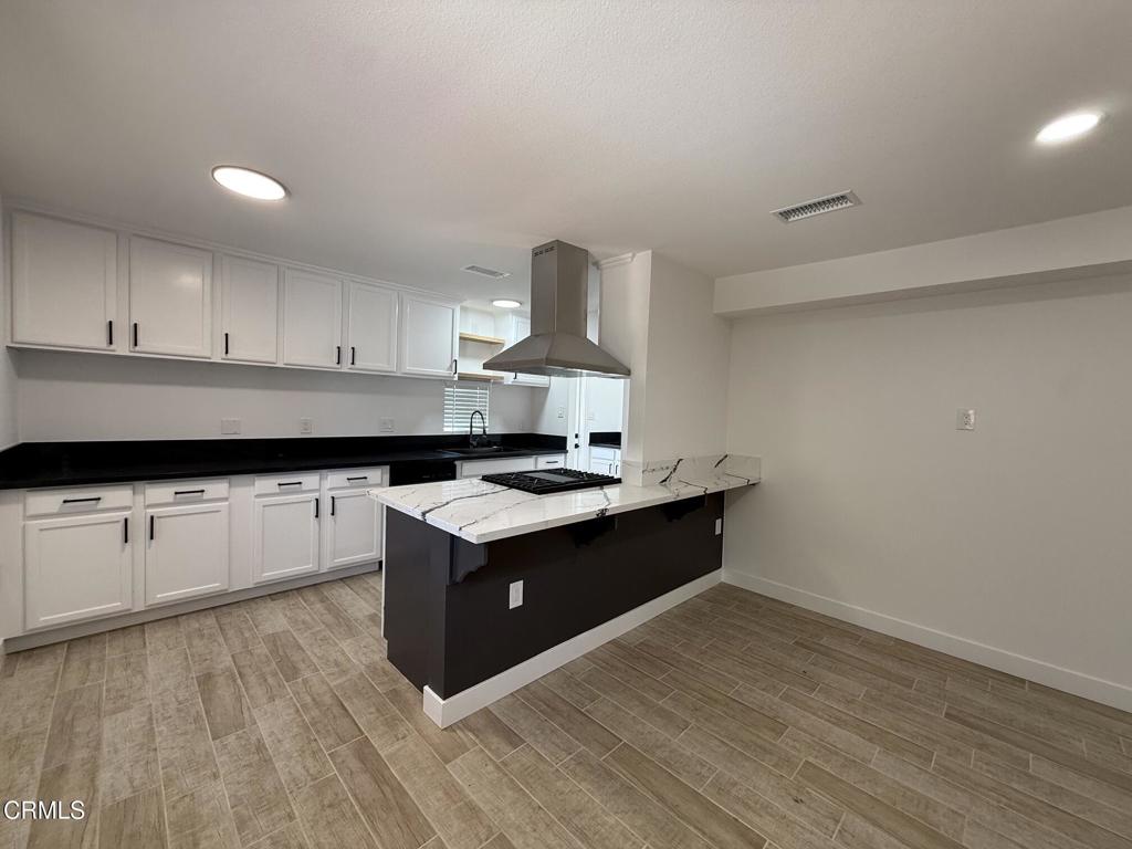 4010 Witt Avenue Riverside, CA 92501 - Photo 2 of 23 a kitchen with granite countertop a sink and a stove top oven
