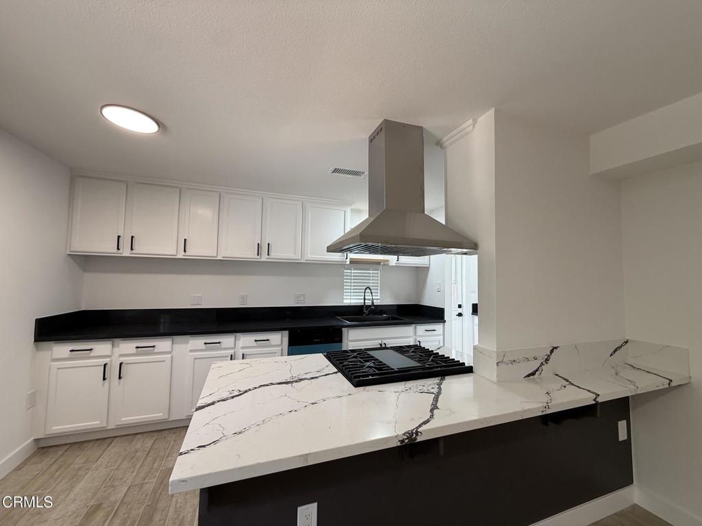 4010 Witt Avenue Riverside, CA 92501 - Photo 3 of 23 a kitchen with a sink a stove and cabinets
