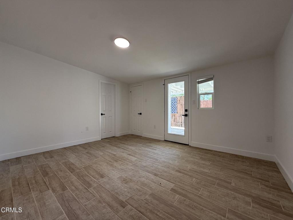 4010 Witt Avenue Riverside, CA 92501 - Photo 7 of 23 an empty room with wooden floor and windows