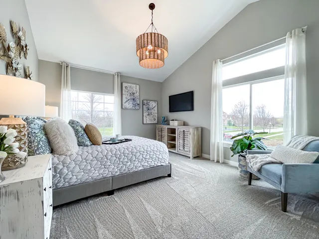 a bedroom with a bed and a chandelier