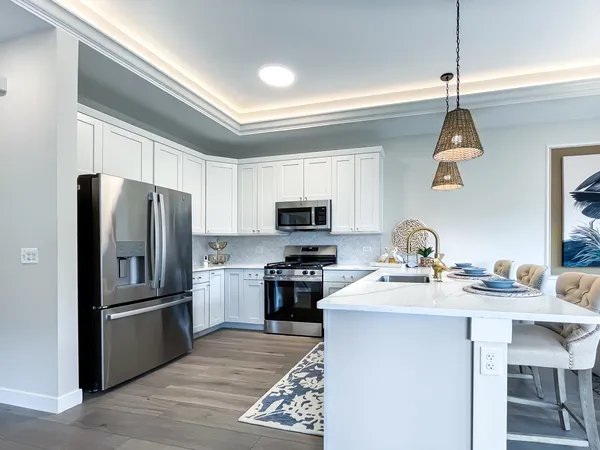 a kitchen with a sink stainless steel appliances and a window
