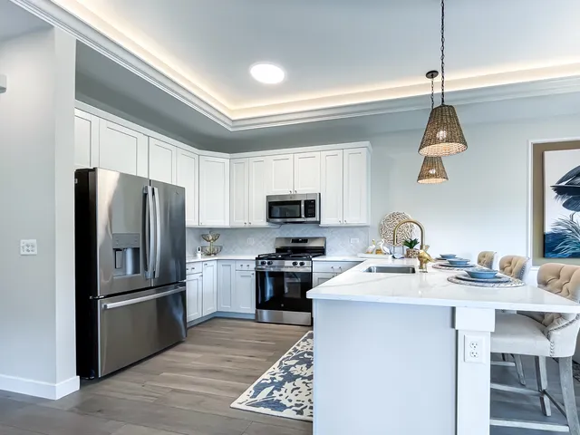 a kitchen with a sink stainless steel appliances and a window