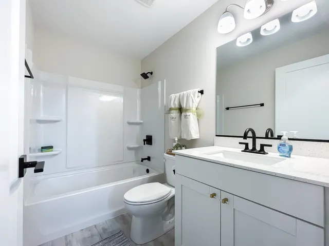 a bathroom with a sink a toilet and a bathtub
