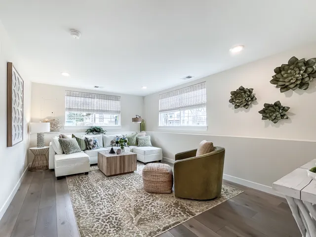 a living room with furniture wooden floor and window