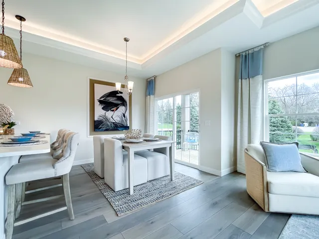 a living room with furniture a rug and white walls