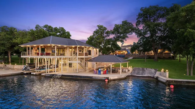 a roof deck with table and chairs