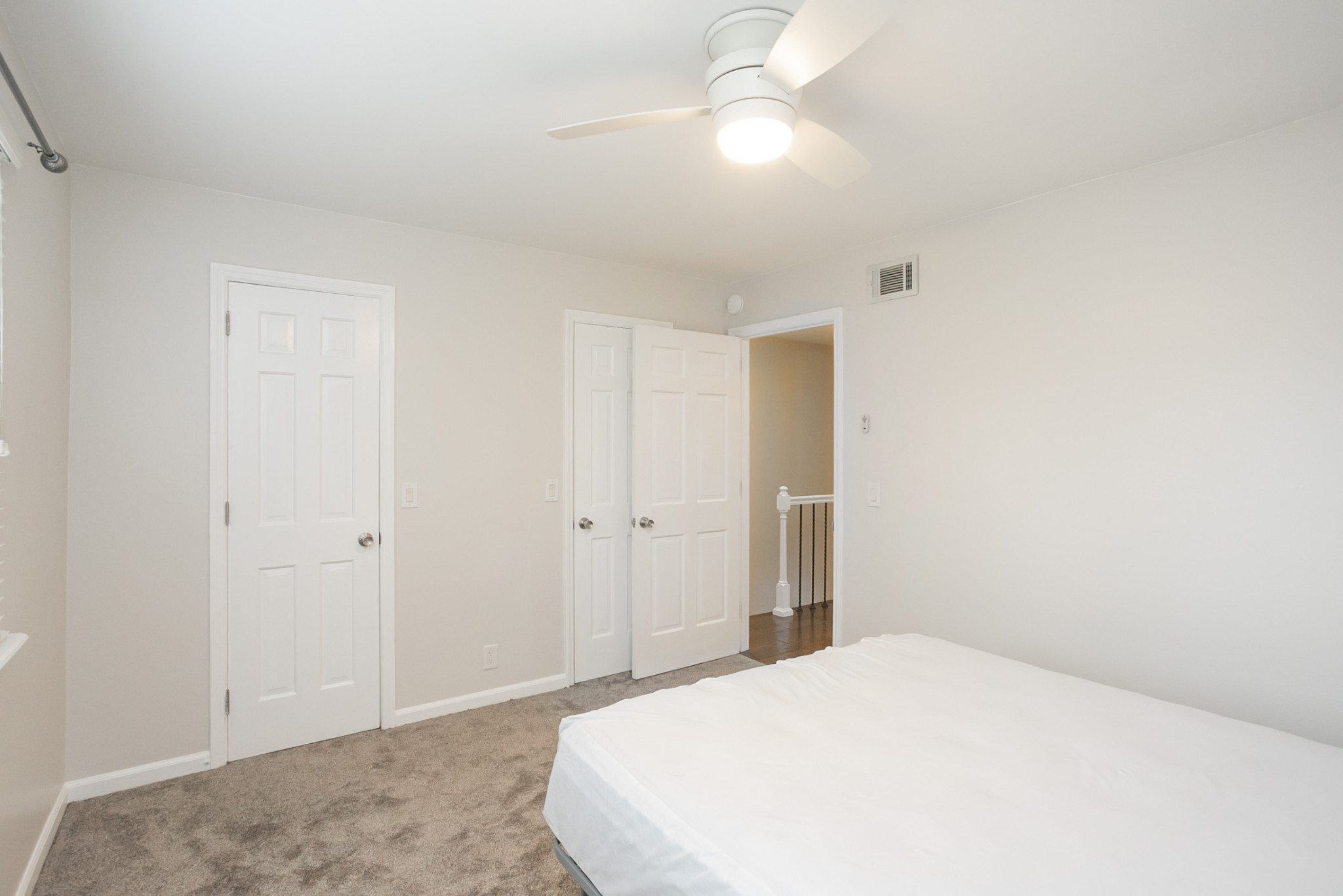 601 Boyd Mill Avenue, Unit C1 Franklin, TN 37064 - Photo 18 of 39 a bedroom with a bed and a chandelier fan