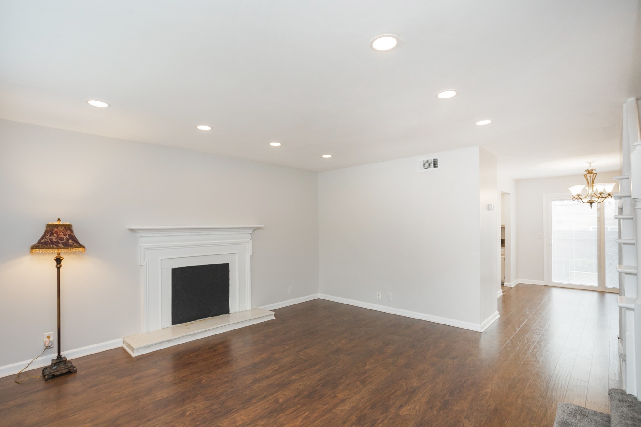 601 Boyd Mill Avenue, Unit C1 Franklin, TN 37064 - Photo 2 of 39 a view of an empty room with wooden floor fireplace and a window
