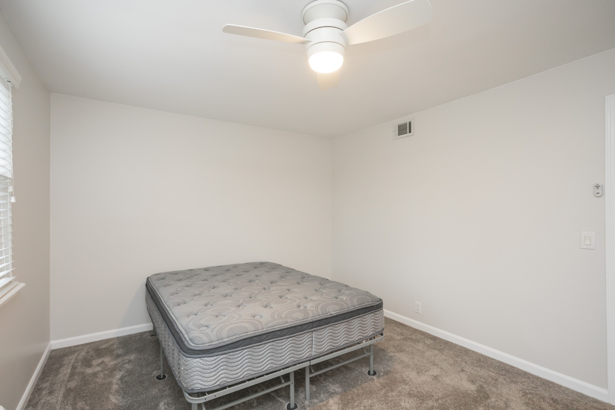 601 Boyd Mill Avenue, Unit C1 Franklin, TN 37064 - Photo 24 of 39 an empty room with wooden floor and fan