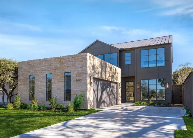 a front view of a building with a garden