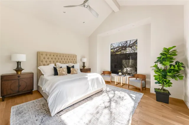 a bedroom with a bed and a potted plant