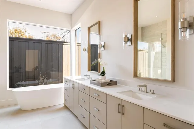 a bathroom with a tub sink and mirror