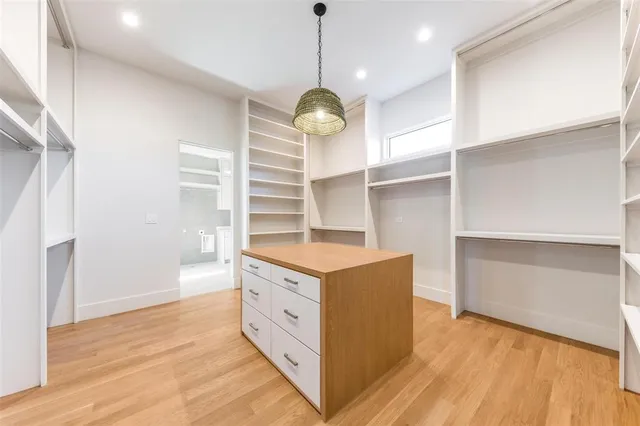 a kitchen with stainless steel appliances granite countertop a stove oven and a wooden floor