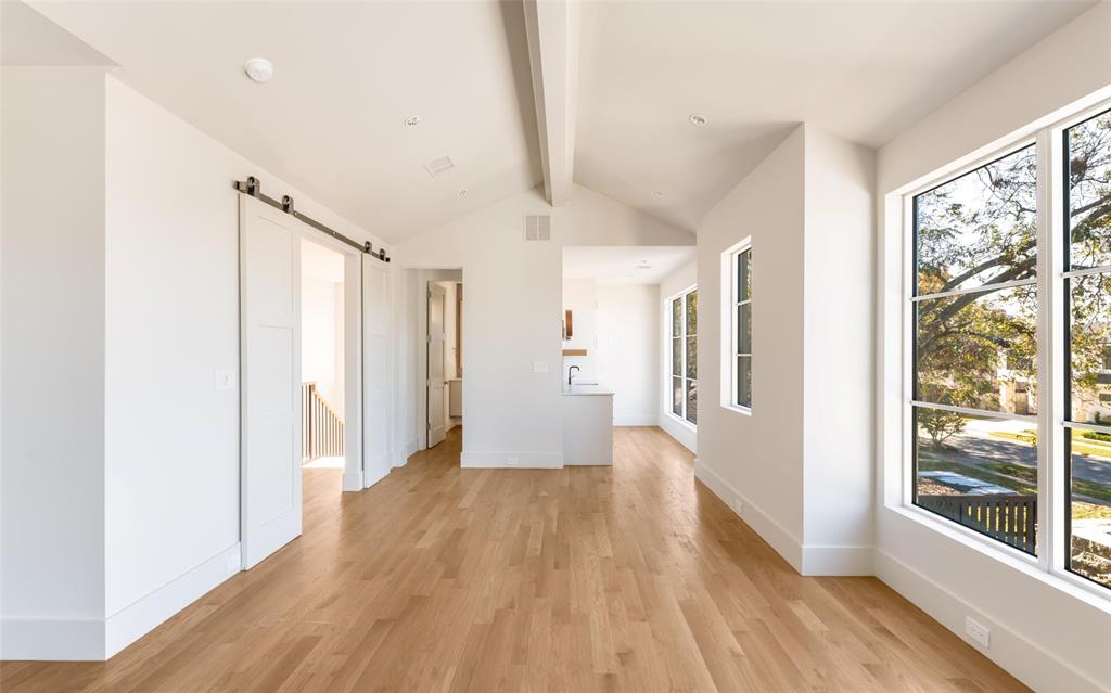 7410 Kenwell Street Dallas, TX 75209 - Photo 29 of 40 a view of a hallway with wooden floor and doors