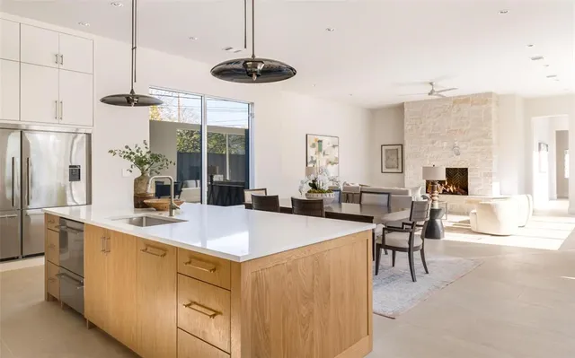 a view of kitchen with sink and refrigerator