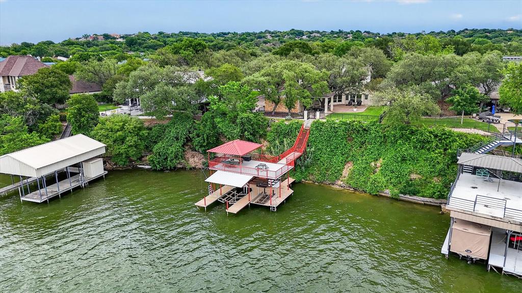 8877 Random Road Fort Worth, TX 76179 - Photo 35 of 40 Two-story boat dock featuring a red metal roof and dual boat slips