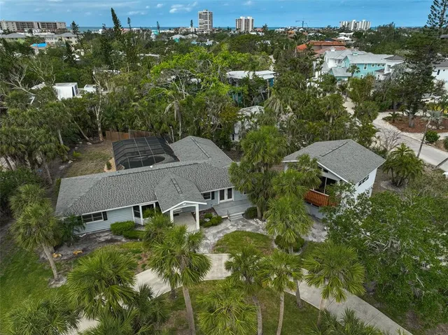 an aerial view of multiple houses with a yard