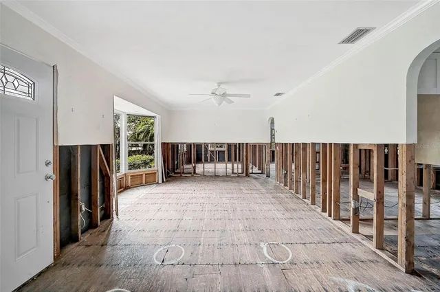 a large bedroom with a large bed and a large window with outer view