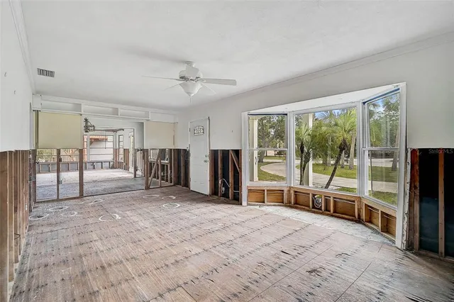 a view of a kitchen with furniture window and stainless steel appliances