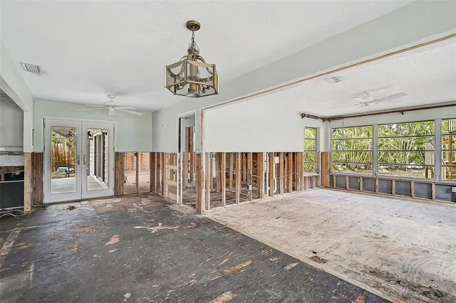 a kitchen with stainless steel appliances a stove a sink a microwave a refrigerator and cabinets