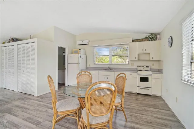 a kitchen with cabinets appliances a sink and a window