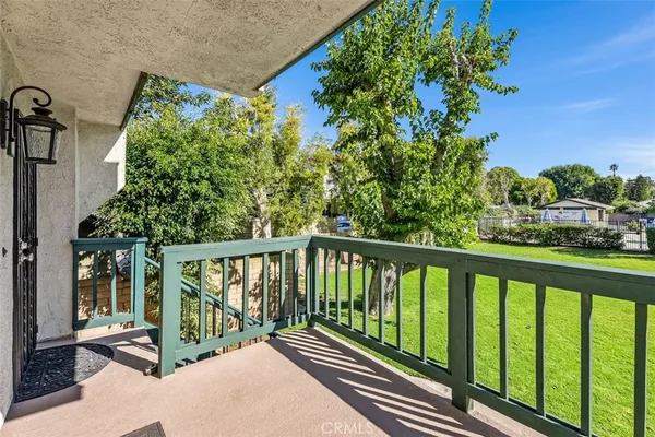 a view of a balcony with wooden floor