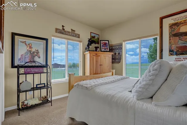 a bedroom with a bed and a painting on the wall