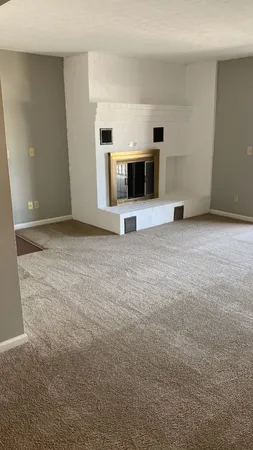 a view of empty room with a fireplace