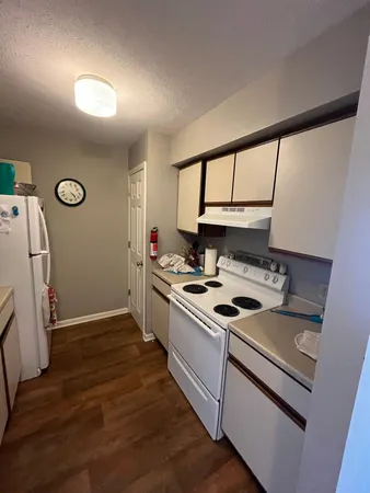 a kitchen that has a sink cabinets and a stove