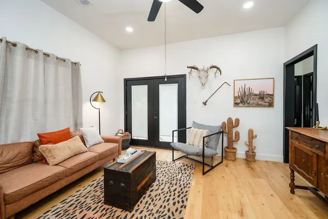 a living room with furniture and wooden floor