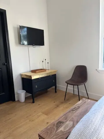 a room with a bed and a flat screen tv