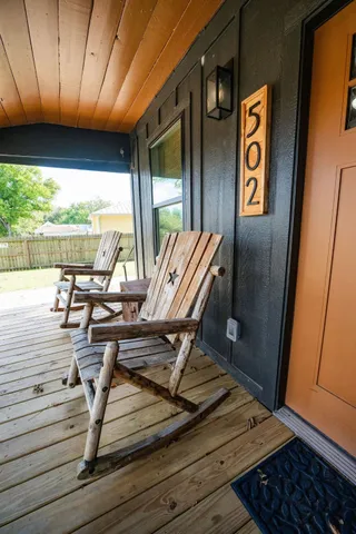 a view of a living room with furniture and floor to ceiling window