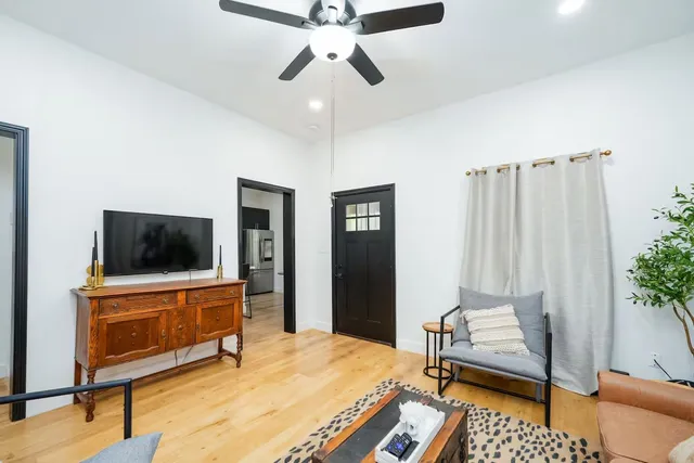 a bedroom with furniture and a flat screen tv