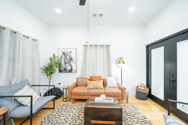 a living room with furniture rug and lamp