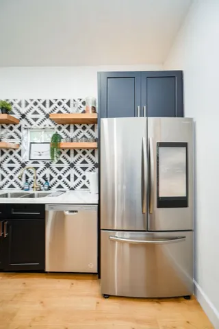 a kitchen with stainless steel appliances granite countertop a refrigerator and a stove