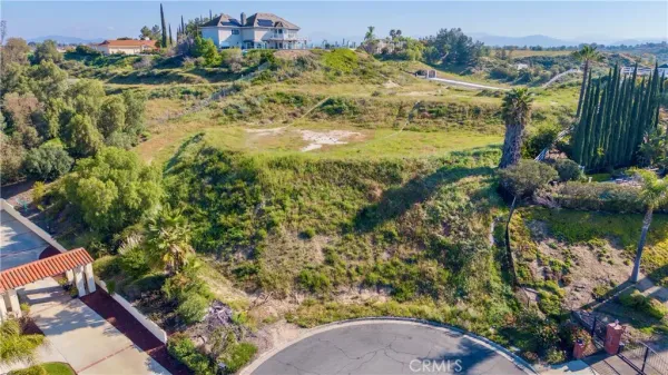 a view of a lush green hillside and houses
