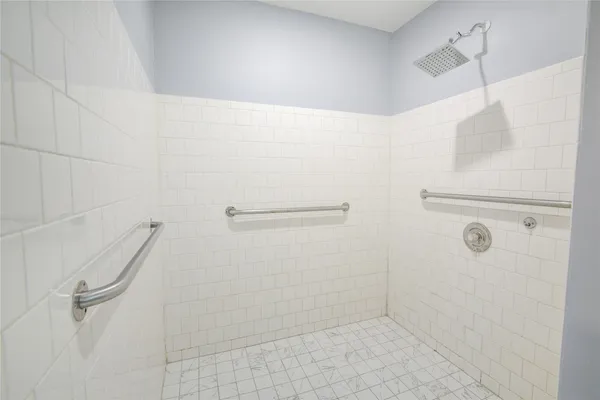 a white house that has tree in front of it