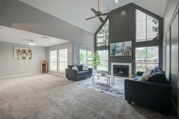 a living room with furniture a fireplace and a large window with outer view